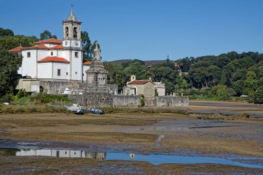 BARRU, SPAIN, September 30, 2023 :Iglesia de Nuestra Se&ntilde;ora de los Dolores and its reflection on waters at low tide.