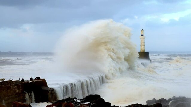 Waves striking the breakwater during storm Babet at Aberdeen, Scotland, on 20th October 2023