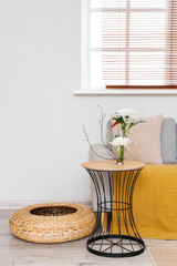 Fototapeta premium Beautiful ikebana on table in living room