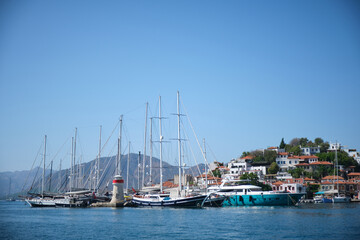 Fototapeta premium Yachts at the pier near the lighthouse.