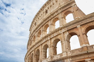 Obraz premium Background made of Colosseum with blue sky and clouds. Rome. Italy. Horizontally. 