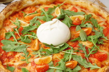Tasty pizza with Burrata cheese on table, closeup
