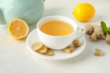 Obraz na płótnie Canvas Cup of ginger tea with lemon on white background