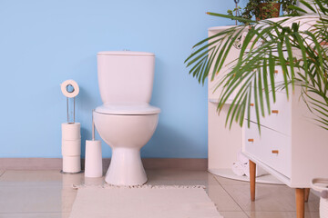 White toilet bowl in interior of restroom