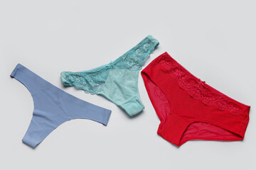 Set of female panties on grey background