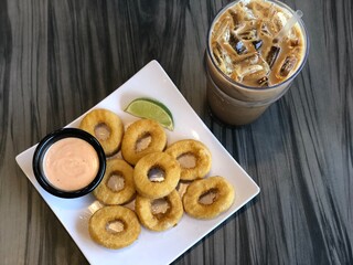 Vegan Fried Calamari with a glass iced coffee. Healthy vegan meal. 