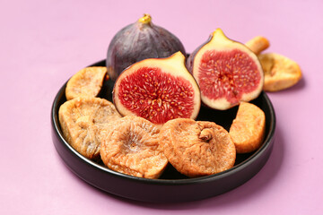 Plate with sweet dried figs and fresh fruits on purple background