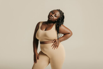 Beautiful young curvy woman in underwear looking confident in her body on studio background - obrazy, fototapety, plakaty