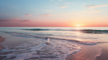 Fototapeta premium A lonely beach stands against a wide expanse of ocean, the sun setting in the distance and casting a beautiful pink light 