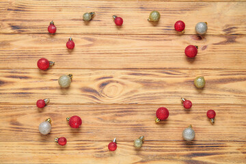Frame made of beautiful Christmas balls on wooden background