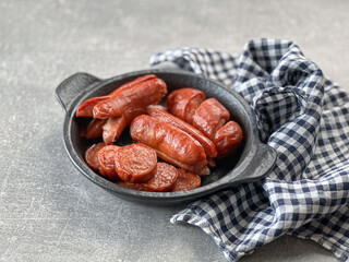 Roasted sausage. Different ways of slicing sausages on stick. 