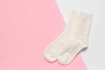 Warm socks on color background