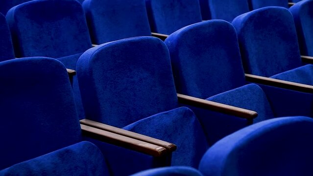 Blue empty seats in the audience prepared for the participants of the conference or presentation