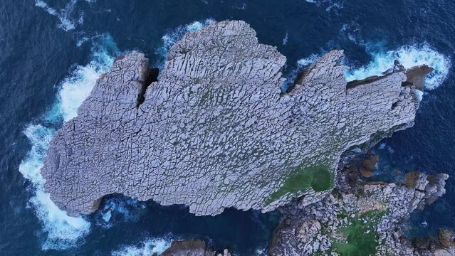 Coast, waves, karst and on the peninsula called La Roca Blanca, around the town and lighthouse of Suances. Aerial view from a drone. Suances Municipality. Cantabrian Sea. Cantabria. Spain. Europe