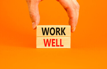 Work well symbol. Concept words Work well on beautiful wooden block. Beautiful orange table orange background. Businessman hand. Business marketing, motivational work well concept. Copy space.