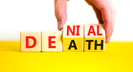 Denial death symbol. Concept words Denial Death on wooden block. Beautiful yellow table white background. Businessman hand. Business denial death concept. Copy space.