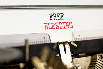 Free bleeding symbol. Concept words Free bleeding typed on beautiful old retro typewriter. Beautiful white paper background. Gen Z, motivational, freedom free bleeding concept. Copy space.