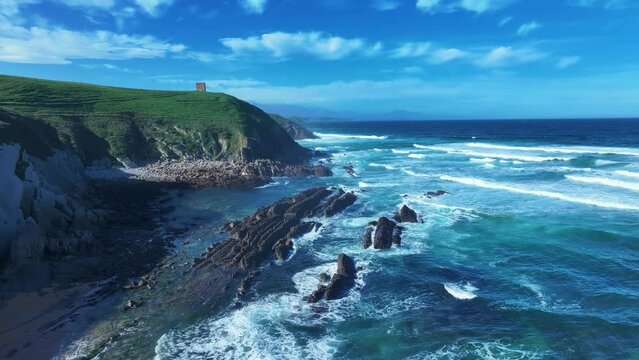 Coastal landscape with waves around El Sable beach in the town of Tagle. Aerial view from a drone. Suances Municipality. Cantabrian Sea. Cantabria. Spain. Europe