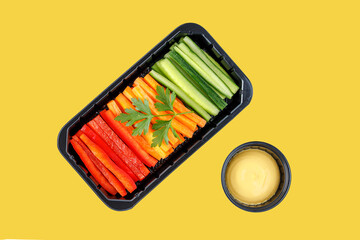 sweet pepper carrots and cucumber cut into strips on a yellow background 1