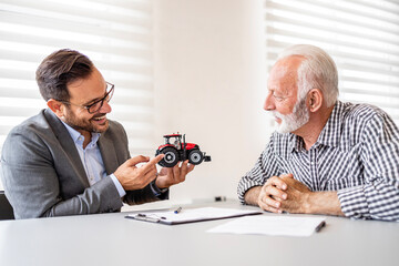 Farmer investing in new agricultural machinery and farming equipment.