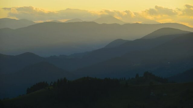 Hikers shelters on mountainside. Beautiful nature landscape. Time lapse of colorful sunset in wild mountains