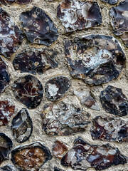 An example of the use of local flint stone and brick in wall masonry. Selective focus 