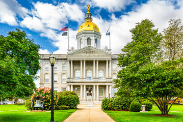 New Hampshire State House with the statue of Daniel Webster a prominent NH statesman, in Concord....