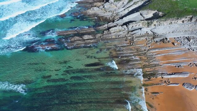 Colors and rock formations of El Sable beach. Coastal landscape in the town of Tagle. Aerial view from a drone. Suances Municipality. Cantabrian Sea. Cantabria. Spain. Europe