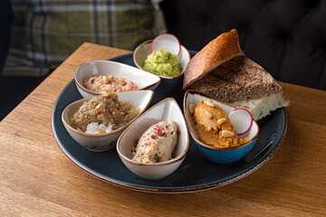 Set Healthy snack or snack with Hummus, rabbit pate, eggplant caviar, guacamole, tuna pate in bowls.