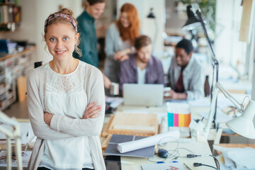 Portrait of a young smiling designer in a modern office