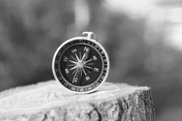 black and white photo of round compass as symbol of tourism - 665818966