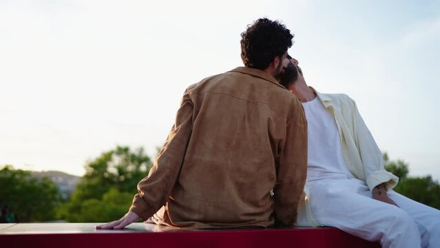 Loving Tenderness, In moment of pure affection males gays share a heartfelt gaze, symbolizing deep love and accepting their LGBT relations. Happy homosexual male couple kissing while dating outdoors