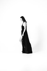 Beautiful black-haired woman, girl, in a black dress, on a white studio background, Lithuanian pianist, accompanist, artist