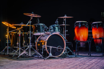 Drums and drum set. Beautiful blue and red background, with rays of light. Beautiful special effects of smoke and lighting. Musical instrument. The concept of music. 