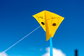 yellow kite on blue sky