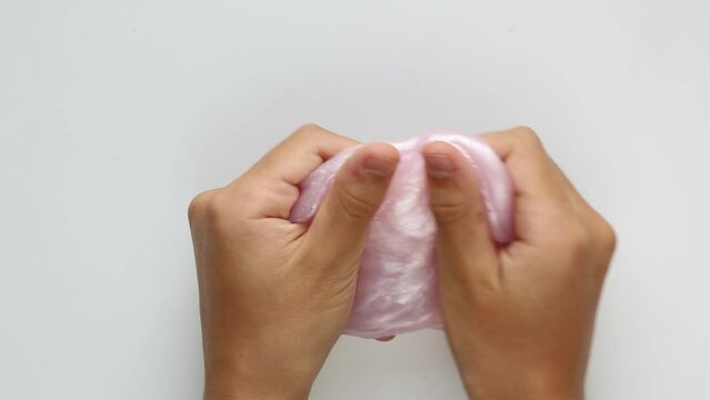 ASMR pink slime in the hands of a teenager. 