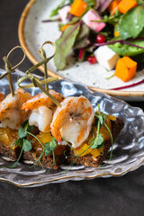 Shrimp and mango chutney canapes in glass plate on dark background. Mini sandwich, catering concept