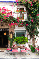 Vibrant view at a restaurant or cafe in old town in Marbella, Spain - obrazy, fototapety, plakaty