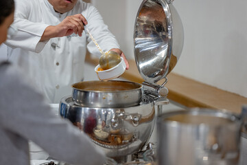 chef holding a plate in the restaurant