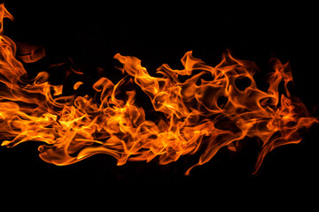 Horizontal orange fire flame against black background, abstract texture, with copyspace