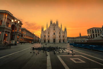 Milan Cathedral (Duomo di Milano) at dawn with typical flock of pigeons in the foreground
