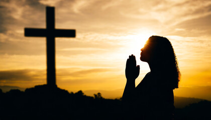 silhouette human raising hands to praying god on blurred cross background