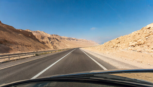driving a car on a mountain road desert landscape the road from arad to the dead sea view from the car of the mountain landscape on a sunny day israel