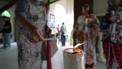 Slow motion devotees engage in candle burning, during the cherished St. Anne's annual feast