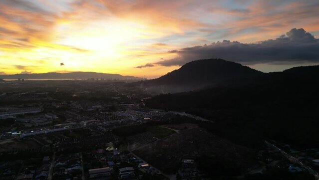 Sunset over a Machang Bubuk, Penang with hill in the background