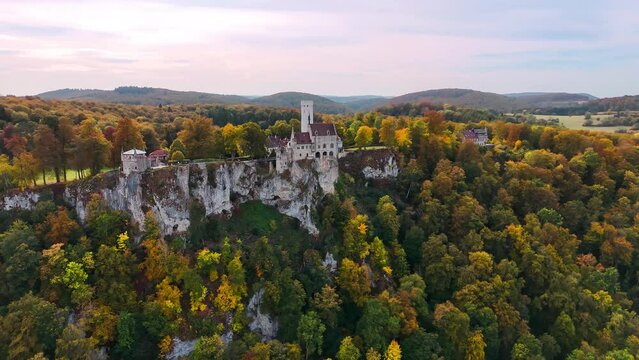 Aerial drone view medieval Lichtenstein castle on mountain, autumn Baden-Wurttemberg, Germany. High quality 4k footage