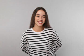 Fototapeta premium Portrait of beautiful young woman on light grey background