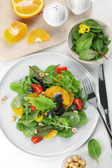 Delicious salad, ingredients and cutlery on white table, flat lay