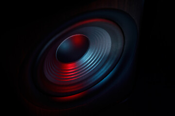 One sound speaker in neon light on black background, closeup