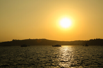 Picturesque view of calm sea with yachts and boats at sunset